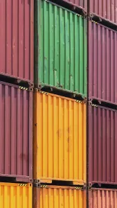 Busy international industrial port with freight and shipment docks and cargo containers