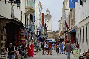 A busy street in the old town of Essouira with lots of shops and people