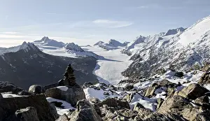 Cairn on the hiking trail to Ramoljoch with snow in autumn