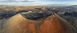 Caldera Colorada volcano, picturesque volcanic landscape with volcanic craters and lava fields in morning light