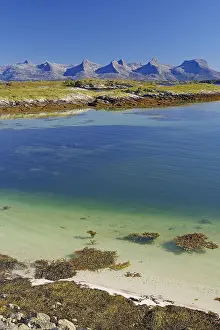 A calm, clear fjord with seaweed