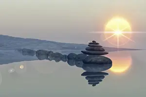 Calm lake beach with stacked stones