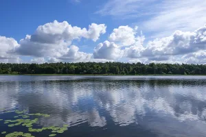 Calm lake with reflection of the clouds in the clear water