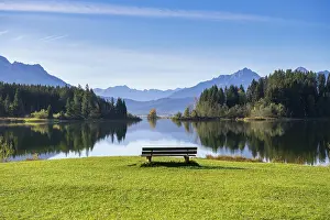 A calm lake surrounded by mountains
