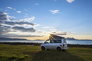 Camper standing by fjord, VW California