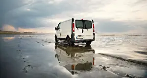 Camper van driving next to the wadden sea at low tide