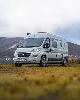 Campervan parked in the parking lot at Fjordbotn Camping