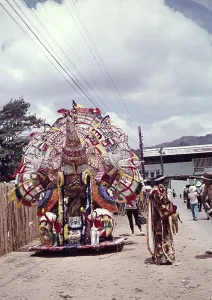 Caption: A lone Indian, elaborate decoration for one person at a carnival, Trinidad 1962