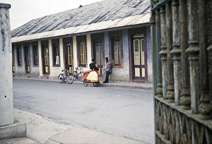 Caption: Street musician in front of Bishop Anstey High School, Port of Spain, Trinidad around 1962