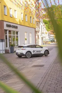 A car parked on a cobbled street with colourful houses