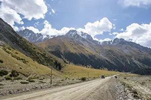 Car on road, mountain valley in the Tien Shan Mountains