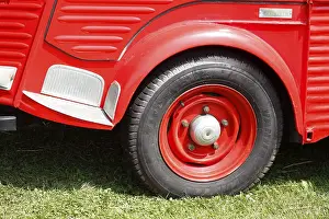 Car tyres on a vintage car, red Citroen van