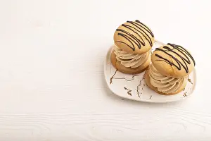 Caramel Cream Cakes on white wooden background