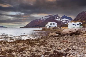 A caravan or mobile home in front of fjord in Norway