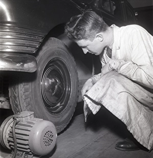 Cars in the 1950s. At this time the yearly mandatory checkup and control of cars was not in affect. Picture taken at the garage of the Swedish Royal Automobile club where a car is controlled that everything is in working order. Sweden 1951