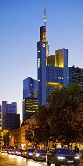Cars on Berliner StraBe and Commerzbank Tower in the evening