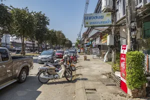 Cars and scooters double parked along Ban Du street in Chiang Rai