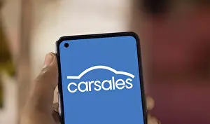 Carsales logo is displayed on smartphone