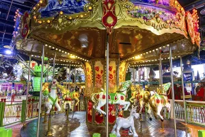 Casablanca, Casablanca-Settat - Morocco - 07-27-2024: Traditional carousel with colorful horses in a brightly lit area