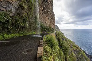 Cascata dos Anjos, waterfall over a road on the coast