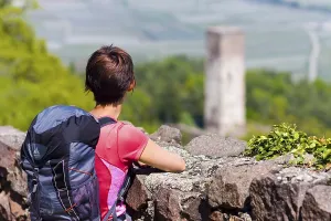 Castle circular walk, hiker in front of the guard tower of Hocheppan Castle