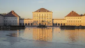 Castle Nymphenburg at sunrise, in front water basin with ducks