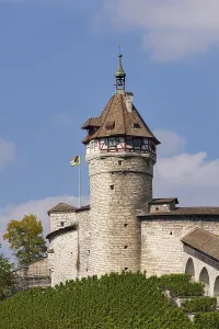 A castle can be seen with a prominent tower against a clear sky