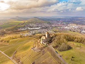 A castle stands above the fields and the village