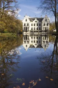 Castle Staverden reflecting in the moat and surrounded by autumn colored trees