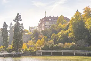 Castle on a wooded hill with autumnal trees
