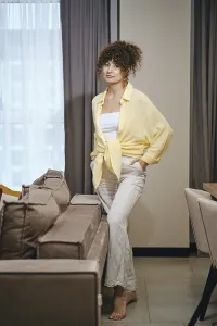 Casual indoor model pose with natural light in a cozy modern living space