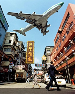 Cathay Pacific aircraft approaching Kai Tak Airport over the rooftops of Kowloon, Hong Kong, China, Asia