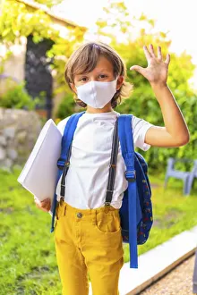 Caucasian child with face mask ready for back to school