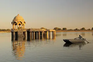 Category Historic EN Prints: Cenotaph called chhatri and pillars reflection and rowing boat in waters of Gadsisar or Gadisar lake