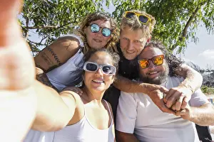 A cheerful group of LGBTQIA+ couples enjoying a sunny day outdoors