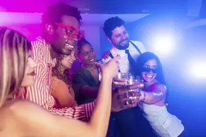 Cheerful multi ethnic friends toasting drinks