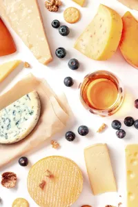 Cheese and wine tasting and pairing flat lay on a white background