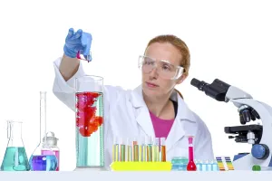 Chemical laboratory scientist woman looking at test tube