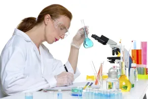 Chemical laboratory scientist woman working with glass flask