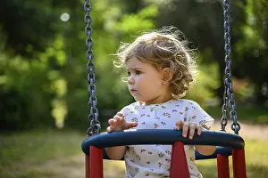 Child, 2 years old, on a swing outdoors