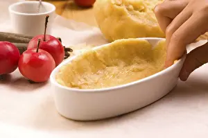 Detail of child hands making apple pie