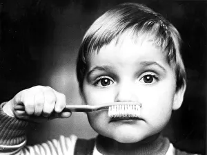 Child with toothbrush, ca. 1980s