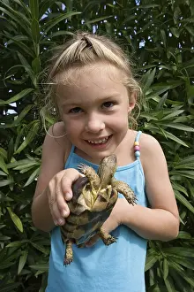 Framed Print : Child with tortoise, Sardinia, Italy