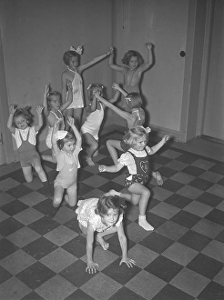 Children in the 1930s. A group of small girls at a dancing school playing together