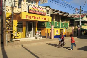 Children cycling on street, Roatan island
