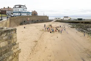 Children enjoying summer holiday activities on sandy beach