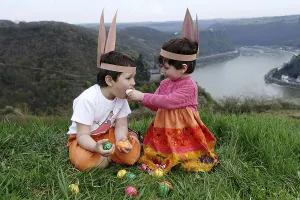 Children looking for Easter eggs at the Rhine River above the Loreley rocks
