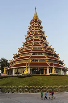 Children playing in front of the nine-story pagoda of the Wat Huay Pla Kang temple