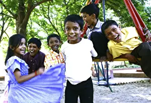 Children playing on swing in a park