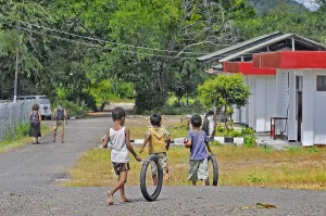Children playing with tyres, Labuan Bajo, Flores Island, Indonesia, Asia